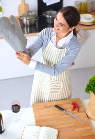 Woman making healthy food standing happy smiling in kitchenの写真素材