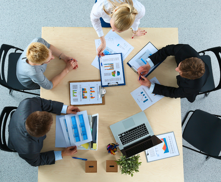 Top view of office workers sitting at a table for meetinの写真素材