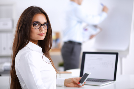 Attractive businesswoman sitting  in the office, at the deskの写真素材