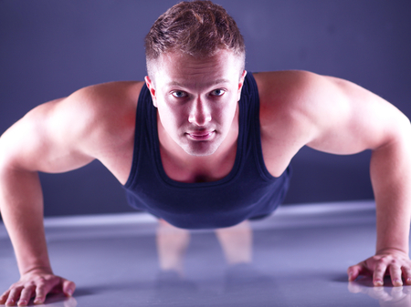 Fitness man doing push ups on floor .の写真素材