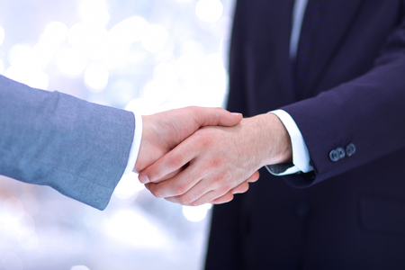 Businessmen shaking hands, isolated on white. Closeupの写真素材