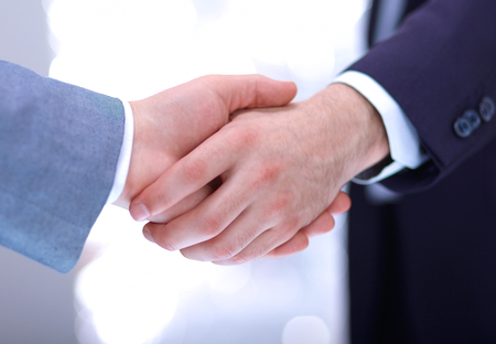 Businessmen shaking hands, isolated on white. Closeupの写真素材