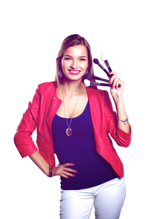 Young beautiful woman holds in hand brush for makeup .の写真素材