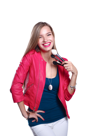 Young beautiful woman holds in hand brush for makeup .の写真素材