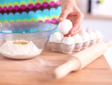 Woman is making cakes in the kitchen .の写真素材