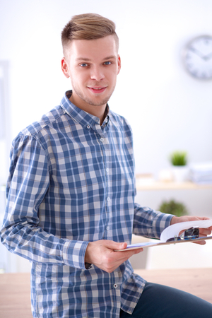 Young businessman working in office , sitting at deskの写真素材