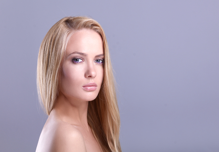 Portrait of a beautiful woman , isolated on grey backgroundの写真素材