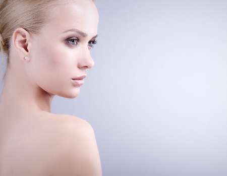Portrait of a beautiful woman , isolated on grey backgroundの写真素材