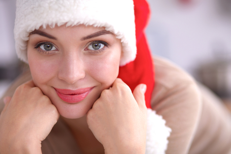 Smiling young woman in the kitchen, isolated on christmasの写真素材
