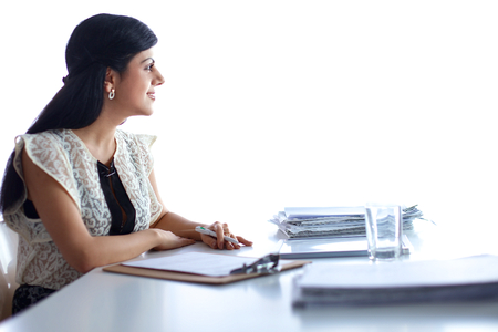 Woman with documents sitting on the desk, in officeの写真素材