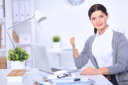 Attractive businesswoman sitting  in the office, isolatedの写真素材