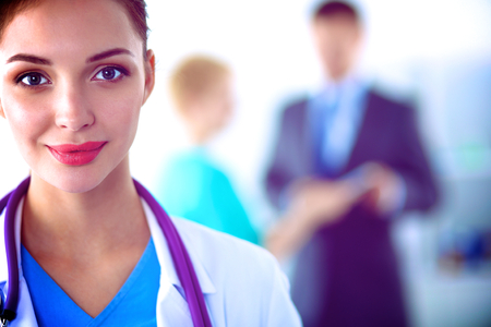 Woman doctor standing with folder at hospital .の写真素材