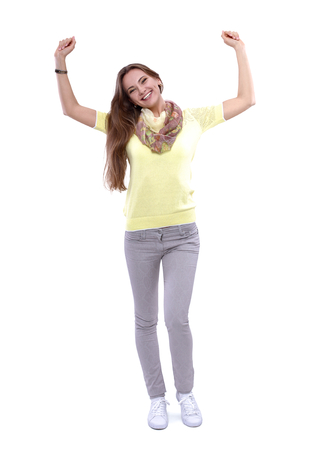 Portrait of a young woman standing on white backgroundの写真素材
