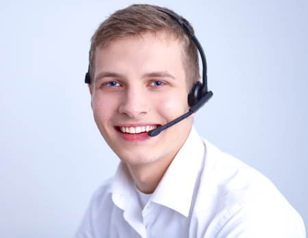 Call center male operator on gray backgroundの写真素材