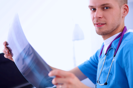 Portrait of a male doctor with x-ray picture of spineの写真素材