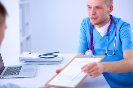 Doctor male giving patient folder with  paper in her officeの写真素材