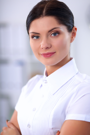 Attractive businesswoman with her arms crossed stndingの写真素材