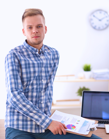 Smiling businessman with red folder isolated on whiteの写真素材