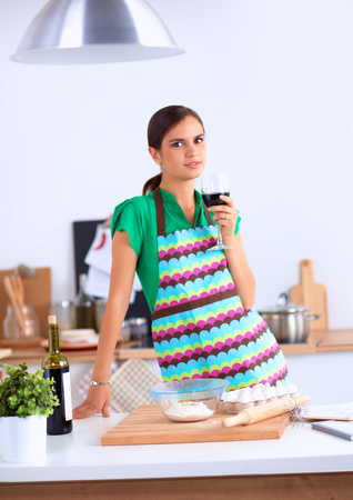 Woman with shopping bags in the kitchen at homeの写真素材