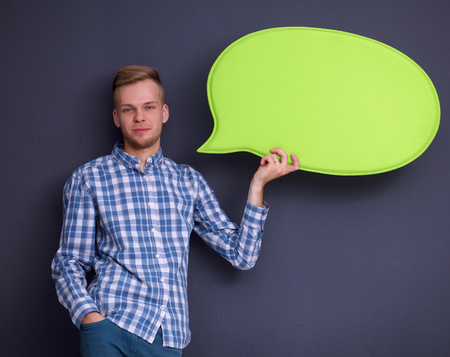 man holding white blank speech bubble with space for textの写真素材