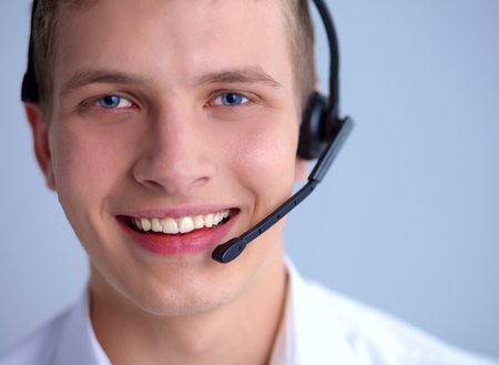 Call center male operator on gray backgroundの写真素材