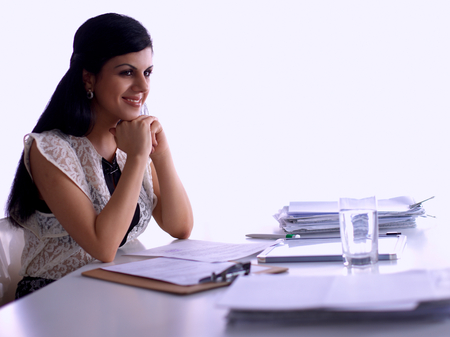 Woman with documents sitting on the desk, in officeの写真素材