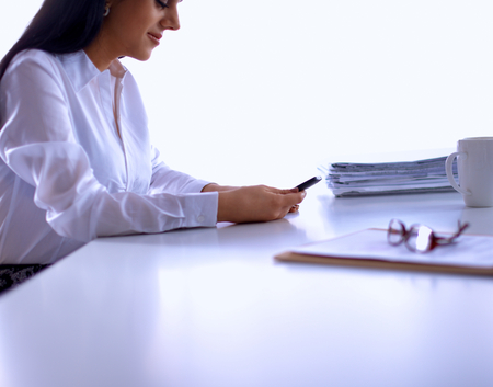 Woman with documents sitting on the desk, in officeの写真素材