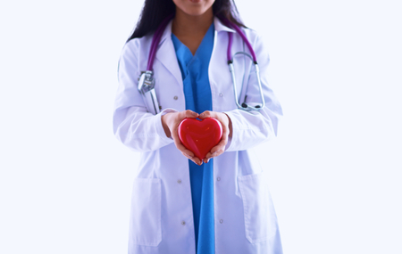 Female doctor with stethoscope holding heart, isolated on white backgroundの写真素材
