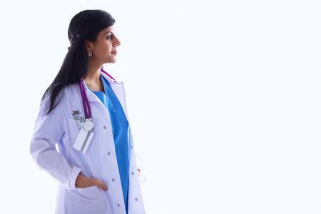 Young doctor woman with stethoscope standing near wallの写真素材