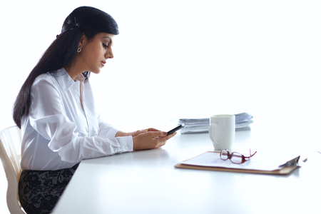Woman with documents sitting on the desk, in officeの写真素材