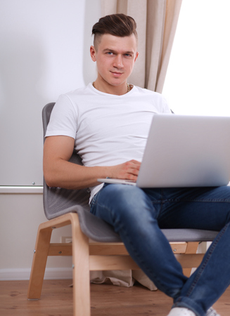 Young businessman working in office, sitting at deskの写真素材