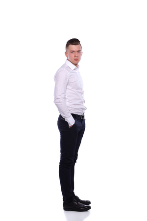 Portrait of a confident man standing over white background.の写真素材