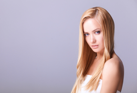 Portrait of a beautiful woman , isolated on gray background.の写真素材
