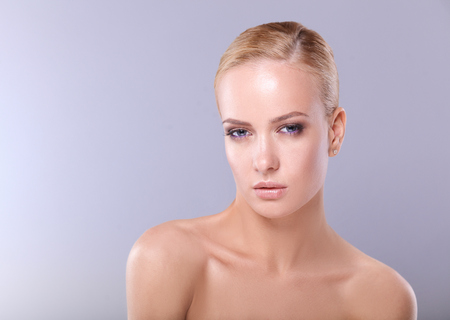 Portrait of a beautiful woman , isolated on gray background.の写真素材