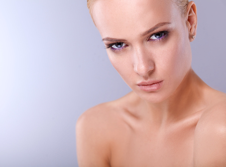 Portrait of a beautiful woman , isolated on gray background.の写真素材