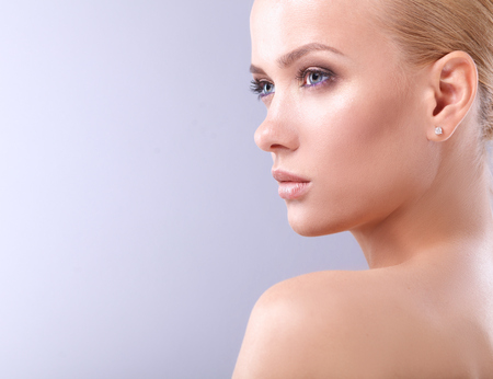 Portrait of a beautiful woman , isolated on gray background.の写真素材