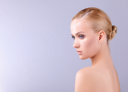 Portrait of a beautiful woman , isolated on gray background.の写真素材