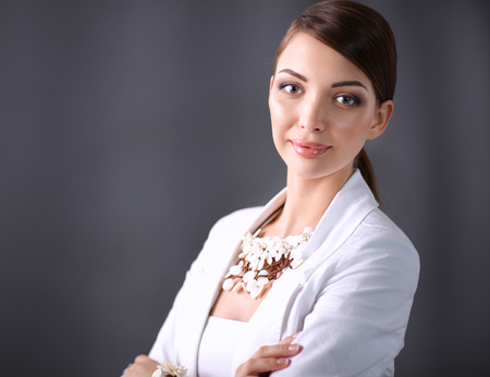 Portrait of pretty young woman with beads, isolated on gray backgroundの写真素材