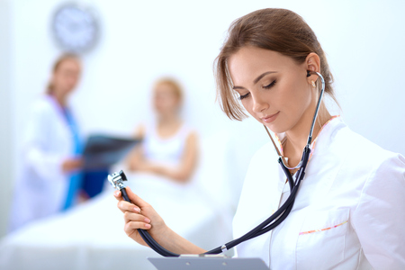 Portrait of woman doctor standing at hospitalの写真素材