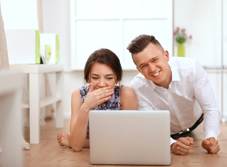 Happy young couple sitting together.の写真素材