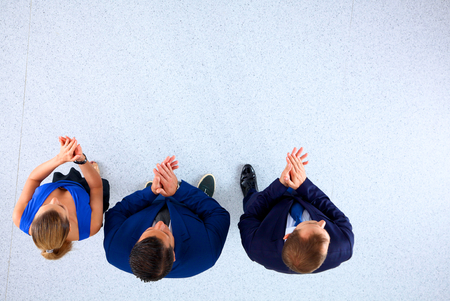 Business people standing together and clapping - top view.の写真素材