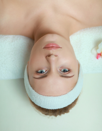 Young woman getting spa massage, lying on spa salonの写真素材