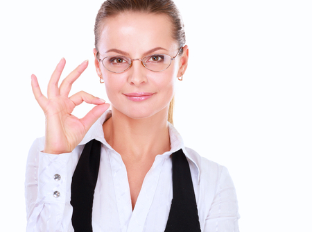A young woman showing ok, isolated on white background.の写真素材