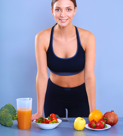Portrait of a pretty woman holding glass with tasty juice.の写真素材