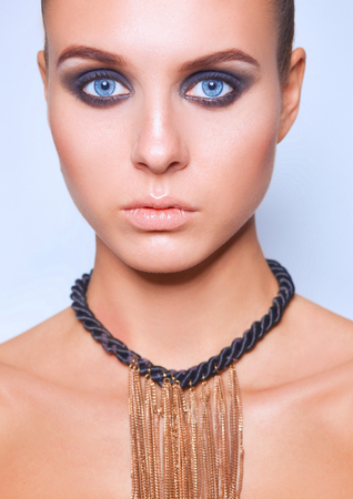 Beautiful woman standing on gray backgroundの写真素材