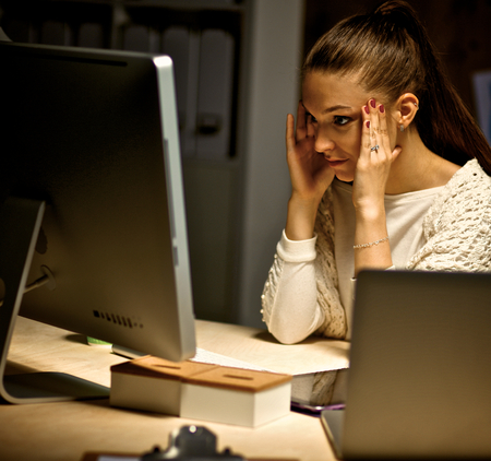 Young and beautiful businesswoman tired from work in the office.の写真素材