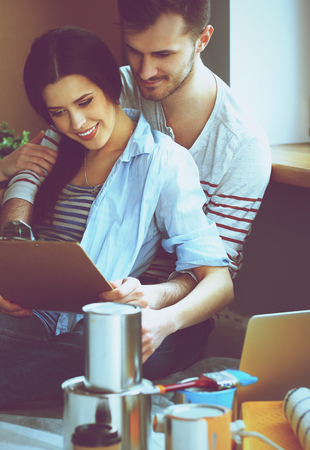 Young couple  sitting on the floor of their new apartment.の写真素材