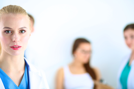 Woman doctor standing with folder at hospital .の写真素材
