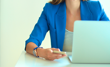 Young businesswoman sitting and talking on phone .の写真素材