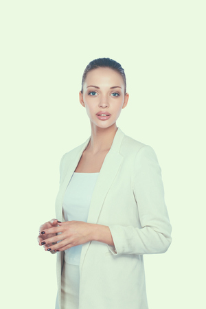 A young woman standing in white background.の写真素材